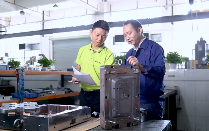 Engineers discussing custom shoulder ejector pin design drawings